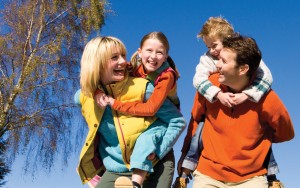 Parents giving children piggyback rides